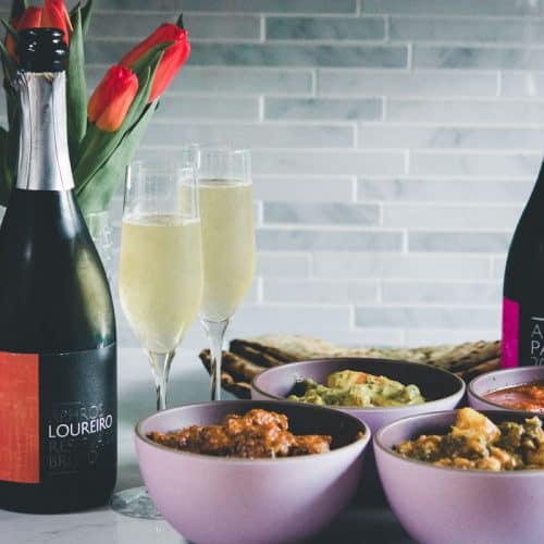aphros sparkling wine with goan curries in pink bowls