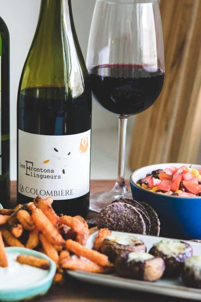 negrette wine bottle and glass with sweet potato fries and salsa