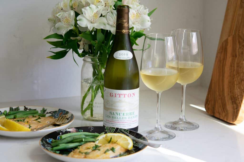 2 glasses of Sancerre wine with 2 plates of sole meuniere