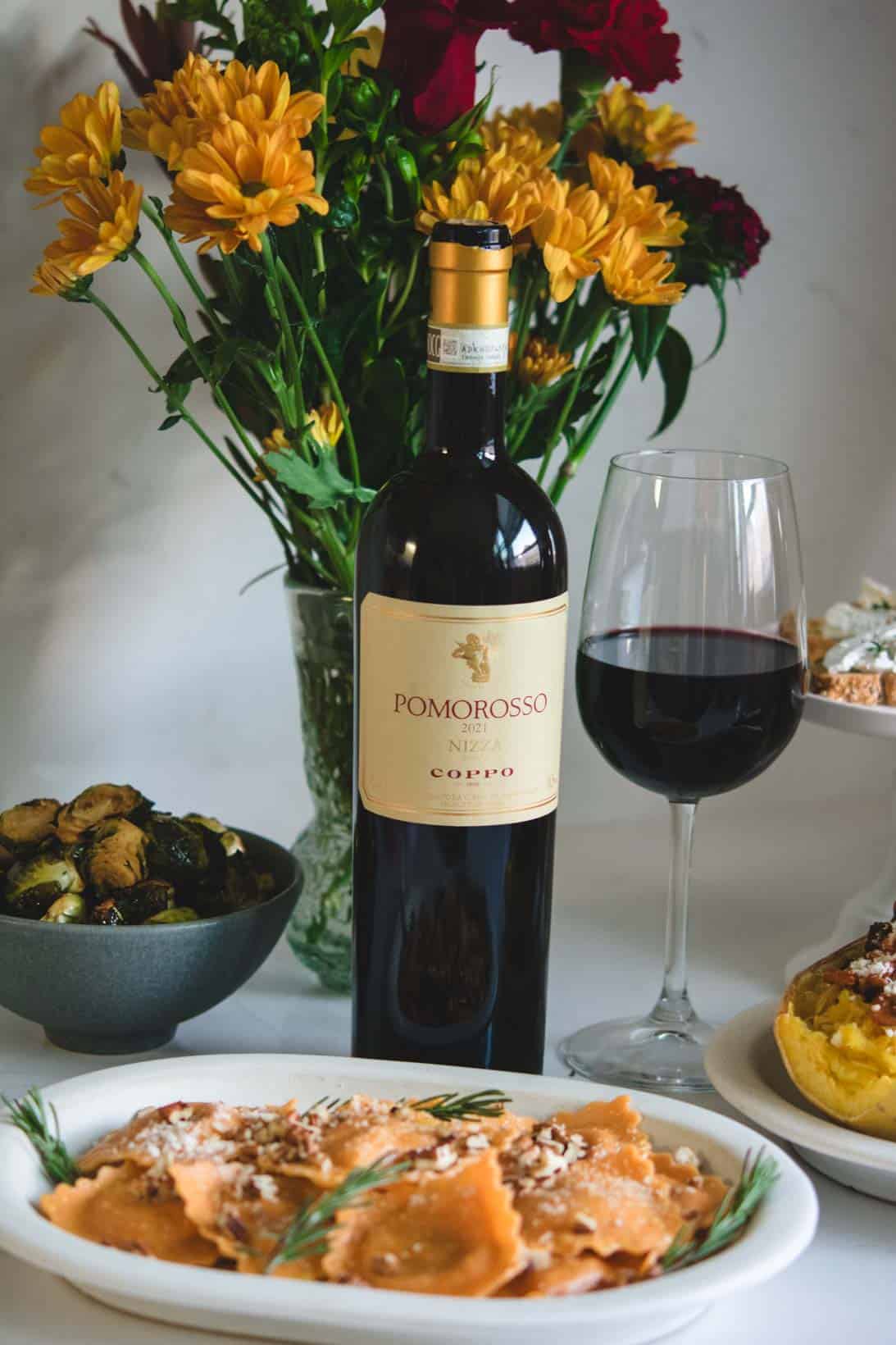 Plates of food with Pomorosso Barbera wine from Coppo Winery