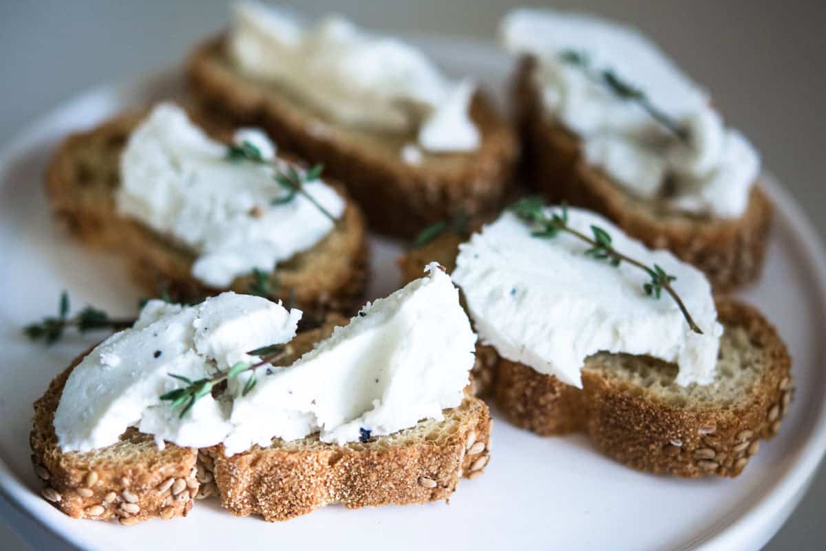 Truffled goat cheese toasts with fresh thyme sprigs