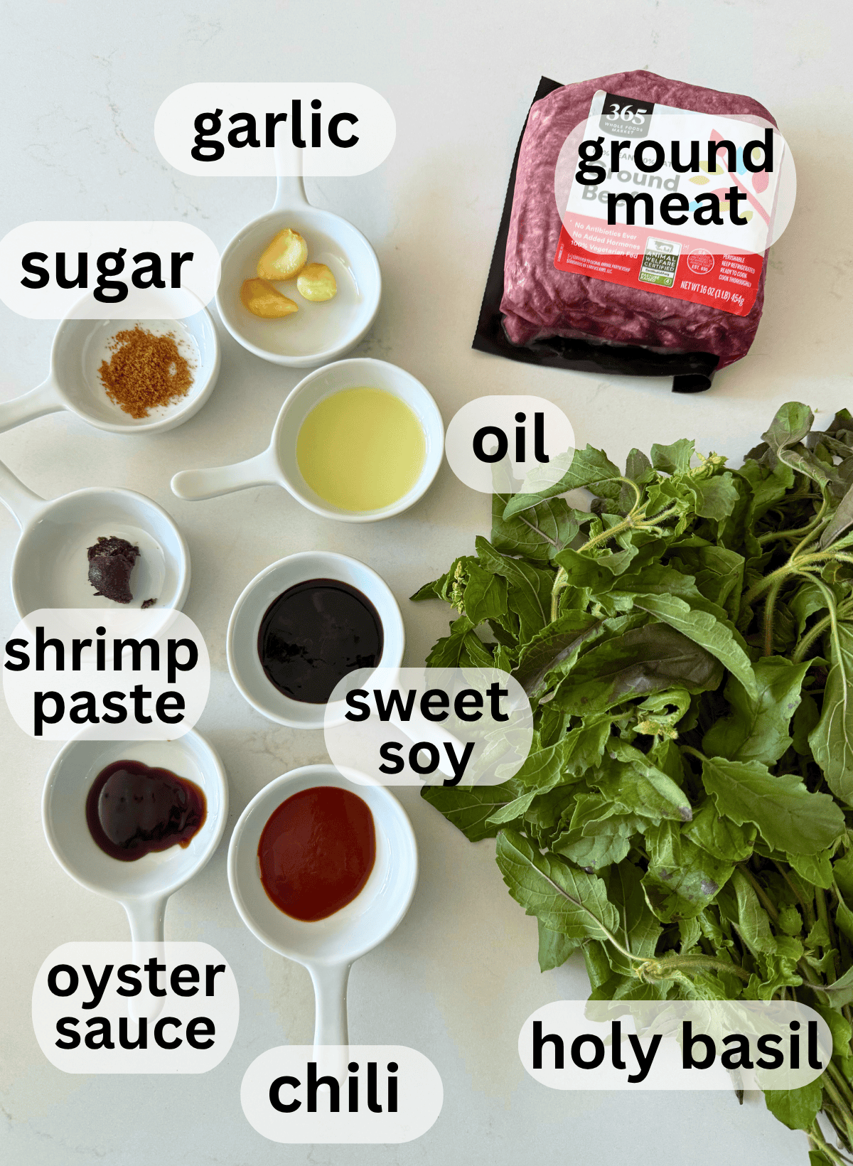Ingredients for beef and vegetables on a white surface.